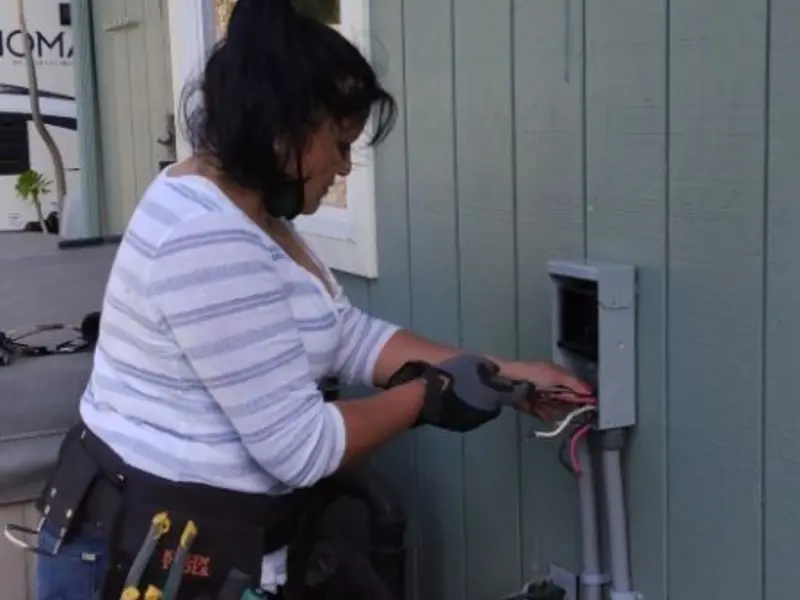 Licensed electrician wiring an exterior subpanel in Clinton